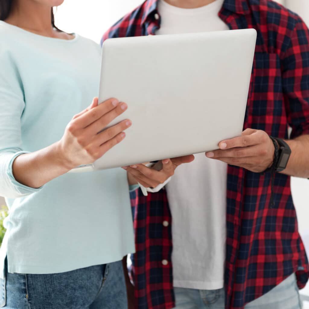 Work together. Pleasant diligent colleagues holding project and standing in the office while working